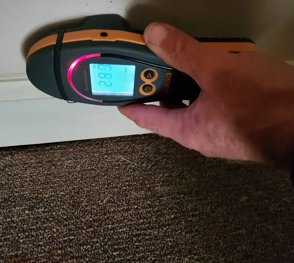 Moisture detection at baseboard during Storm Damage Restoration in Des Moines
